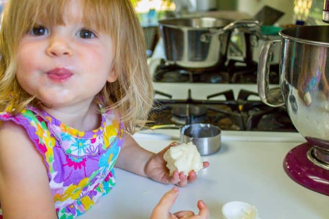 little girl with butter showing how to back caramel cake