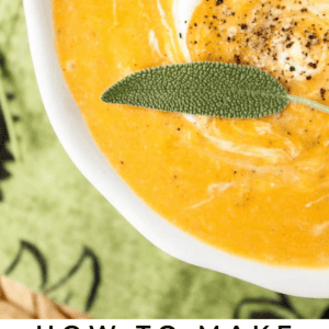 A bowl of creamy butternut squash soup garnished with black pepper, a swirl of cream, and a fresh sage leaf, with text reading “Butternut Squash Soup – The Food Charlatan.”.