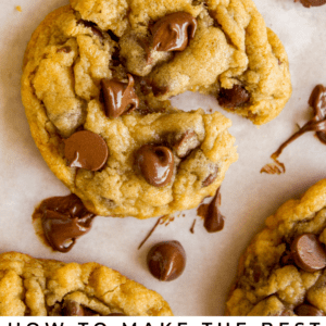 A close-up of soft, gooey chocolate chip cookies with melted chocolate chips on parchment paper. Text at the bottom reads, Chocolate Chip Cookies - The Food Charlatan. Enjoy these irresistible, classic treats.