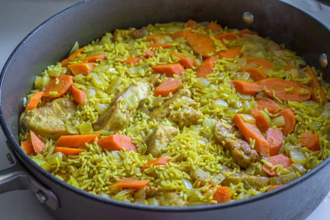 chicken biryani cooking in a skillet.