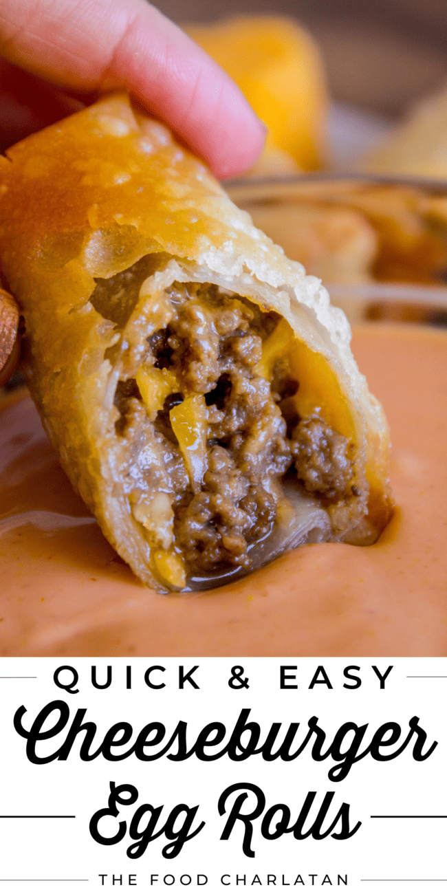 dipping a cheeseburger egg roll in sauce.