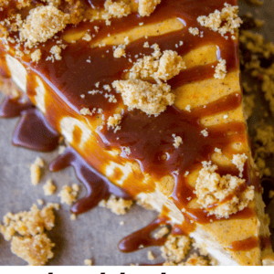 A close-up of a slice of double layer pumpkin cheesecake topped with crumbled crust and caramel sauce. Text below reads: double layer pumpkin cheesecake - The Food Charlatan.