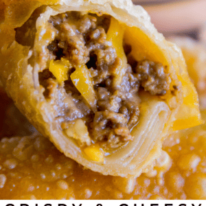 Close-up of a crispy egg roll split open, revealing a cheesy ground beef filling and savory sauce in the background. Text at the bottom reads: Crispy & Cheesy Cheeseburger Egg Rolls. The Food Charlatan.