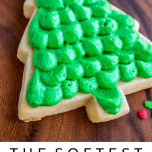 Soft Christmas-tree shaped sugar cookie with dollops of green buttercream frosting