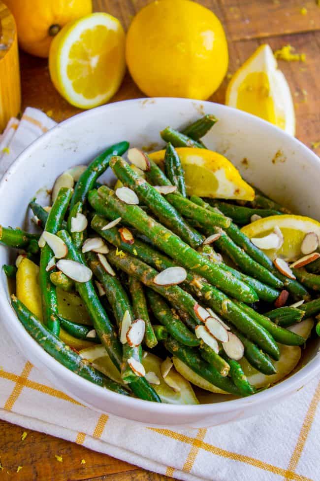 green beans with lemons and almonds in a pan. 