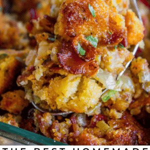 A close-up of a spoonful of classic cornbread stuffing with crispy edges, fresh herbs, and visible bits of bacon, held above a dish brimming with more stuffing. Text at the bottom reads, Homemade cornbread stuffing.