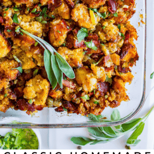 A glass baking dish filled with golden cornbread stuffing, topped with crispy bacon and fresh sage leaves, shown from above with a serving spoon nearby. Text at bottom reads “Classic Cornbread Stuffing with Bacon & Sage.”.