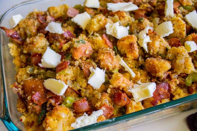 adding butter to cornbread stuffing mixture.