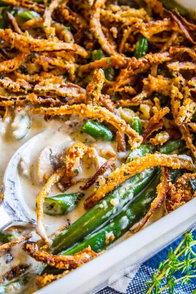 homemade green bean casserole with a serving spoon in it.