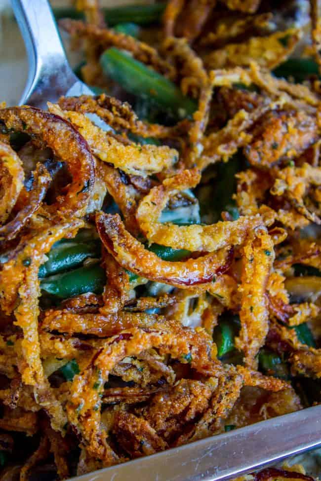 homemade green bean casserole with crispy fried onions shot up close.