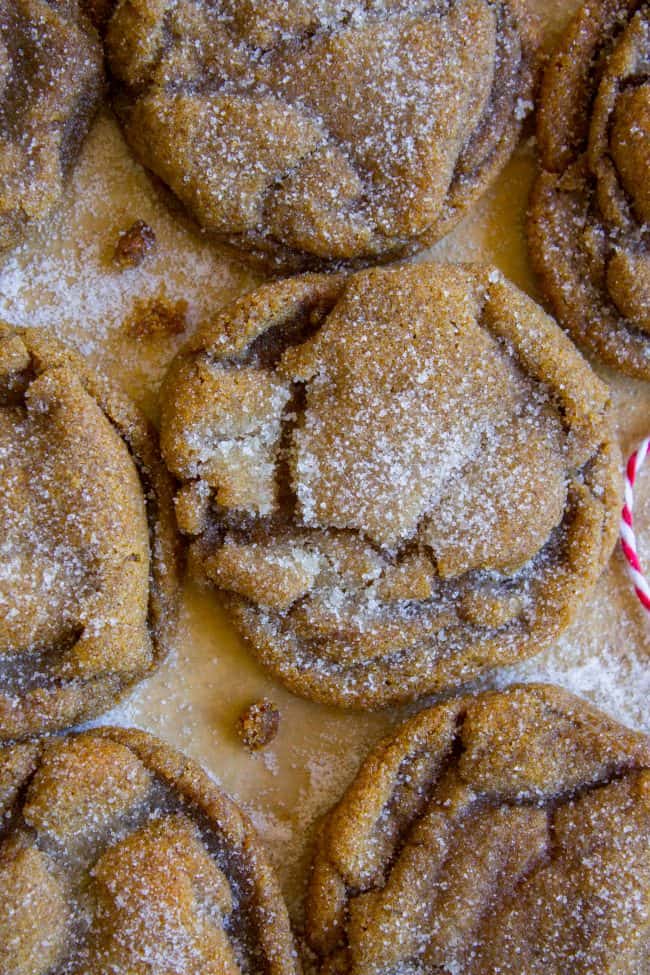 soft sugary molasses cookies on a baking sheet with red and white twine.