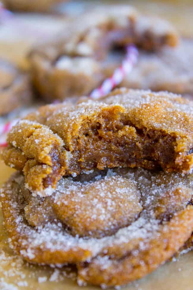 stack of sugary molasses cookies, the top one with a bite taken out of it.