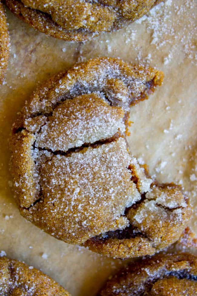 cracked sugary molasses cookie with a bite taken out of it. 