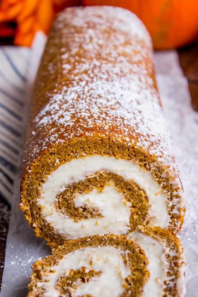 pumpkin roll with cream cheese frosting, dusted with powdered sugar.