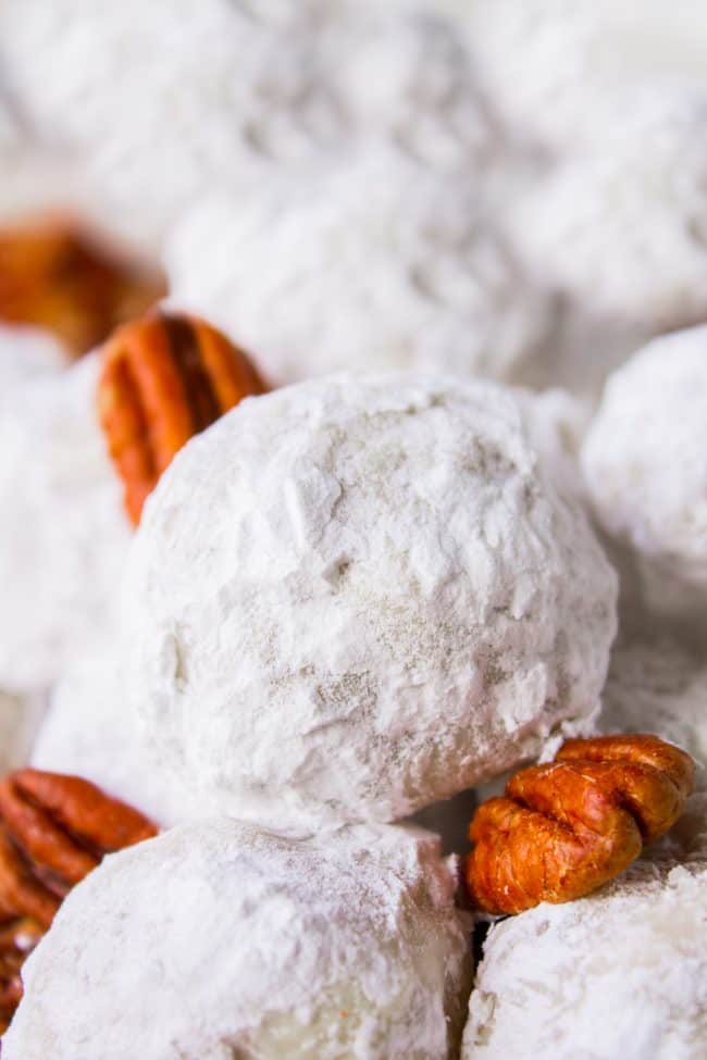 snowball cookies stacked with pecans.