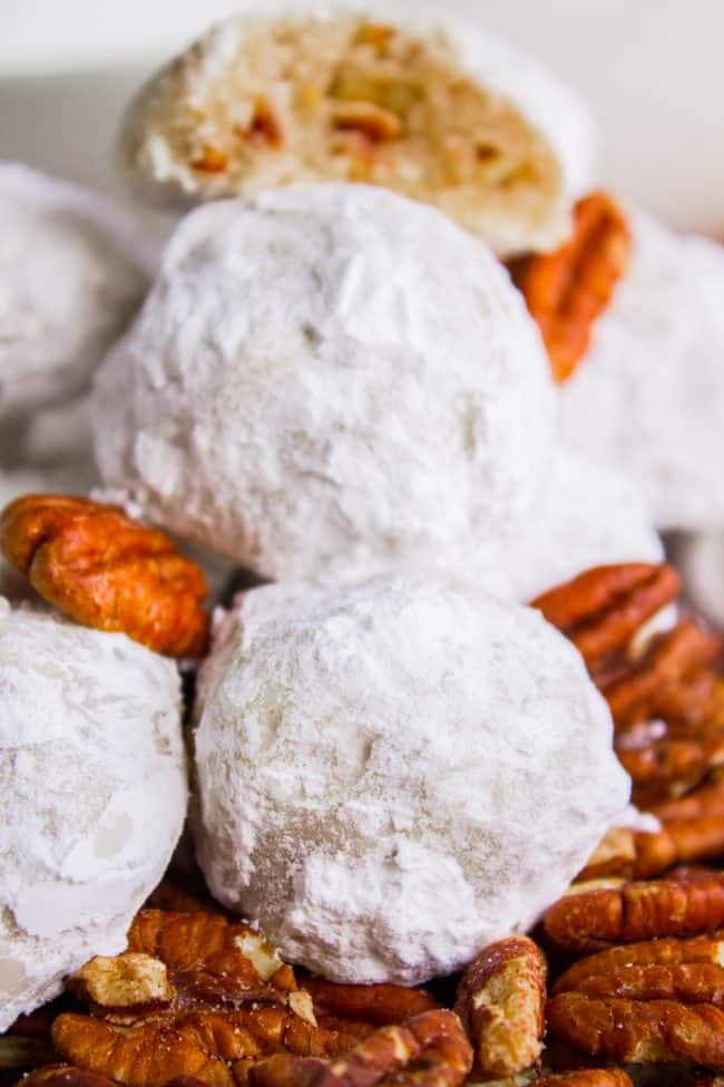 Mexican wedding cookies on top of pecan halves.