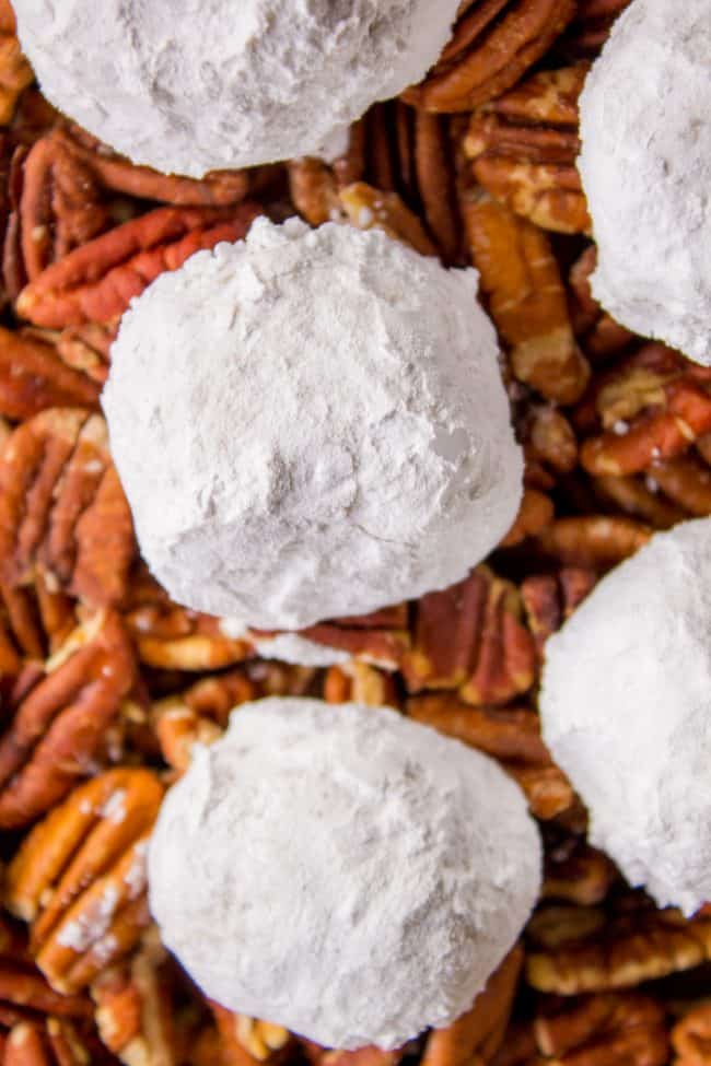 Mexican wedding cookies on top of pecan halves.