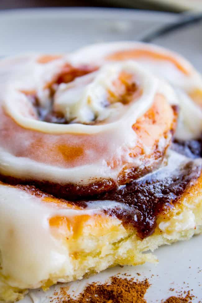 homemade cinnamon rolls with frosting on top.