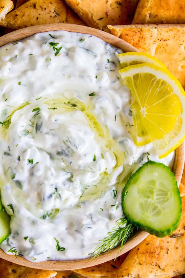 bowl of tzatziki sauce with lemon and cucumber