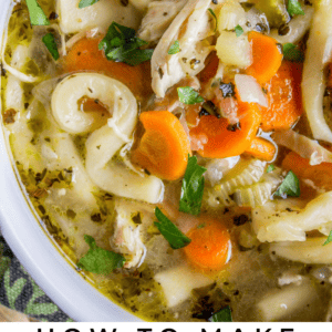 homemade chicken noodle soup in a white bowl.