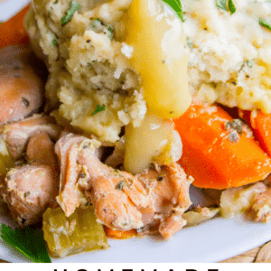 chicken and dumplings with carrots and gravy.