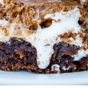 a fork in a slice of Mississippi mud cake with dripping marshmallow creme.