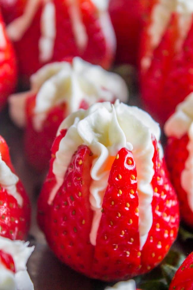 Close-up of strawberries stuffed with cheesecake filling.