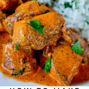 Close-up of chicken tikka masala with tender chicken in an orange sauce, garnished with cilantro, served alongside white rice and naan bread. Text reads, Chicken Tikka Masala. The Food Charlatan.