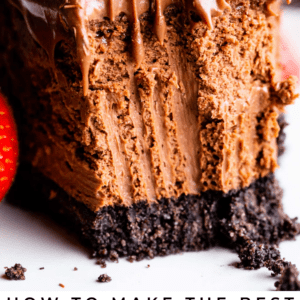 smooth chocolate cheesecake with Oreo crust and a bite removed.