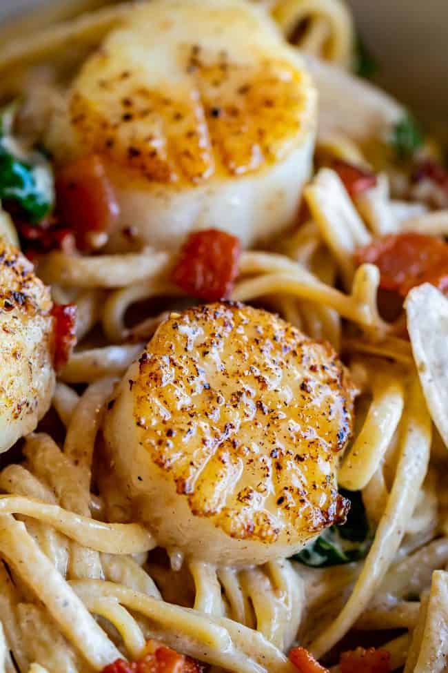 seared scallops in a creamy wine sauce with bacon and spinach over linguine.
