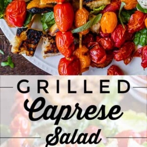 Skewers of grilled cherry tomatoes top a fresh tomato basil mozzarella salad with leafy greens and ciabatta bread pieces. Text overlay reads: Grilled Caprese Salad with Ciabatta.