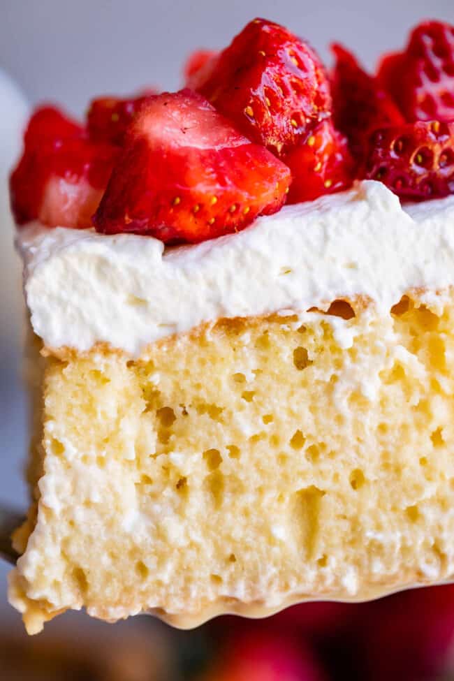 tres leches cake with strawberries on top shot from close up.