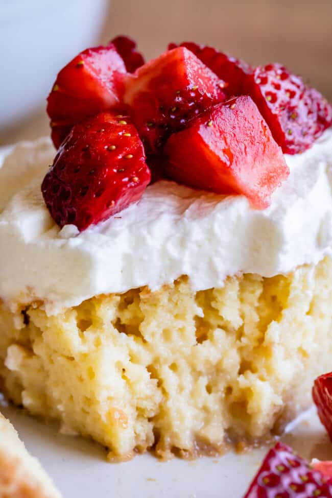 tres leches cake recipe with strawberries on top.