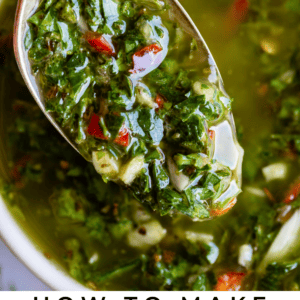 a spoon lifting homemade chimichurri sauce from a small bowl.