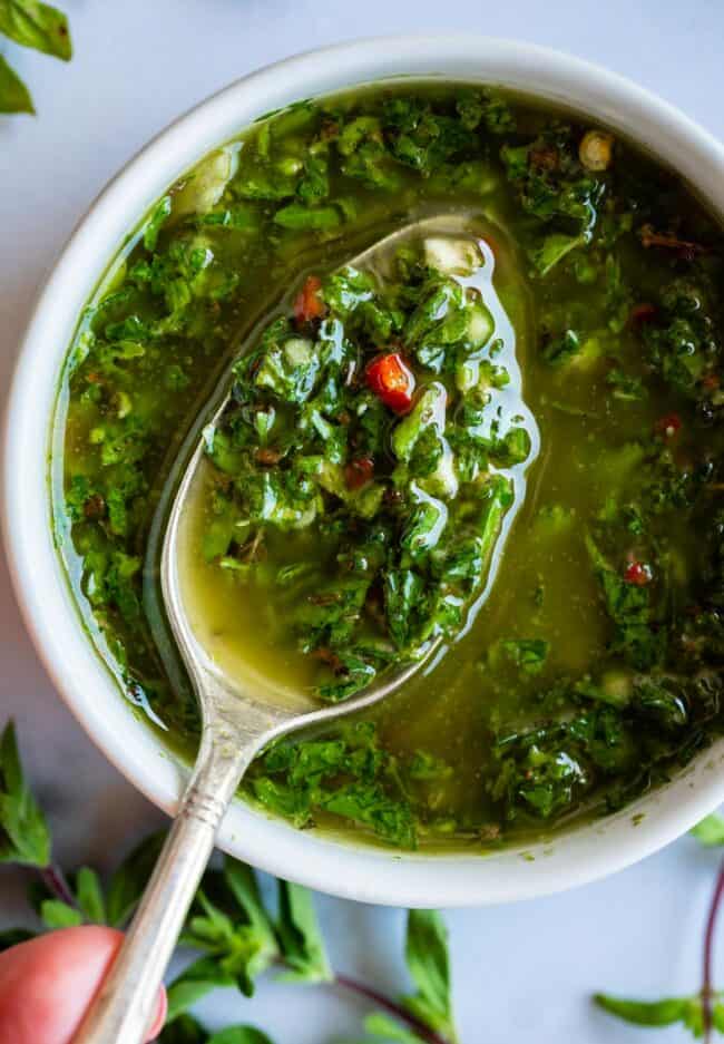 chimichurri sauce with a spoon.