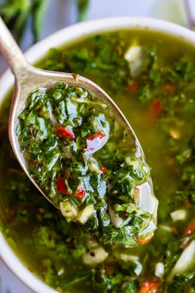 chimichurri sauce being lifted with a spoon. 