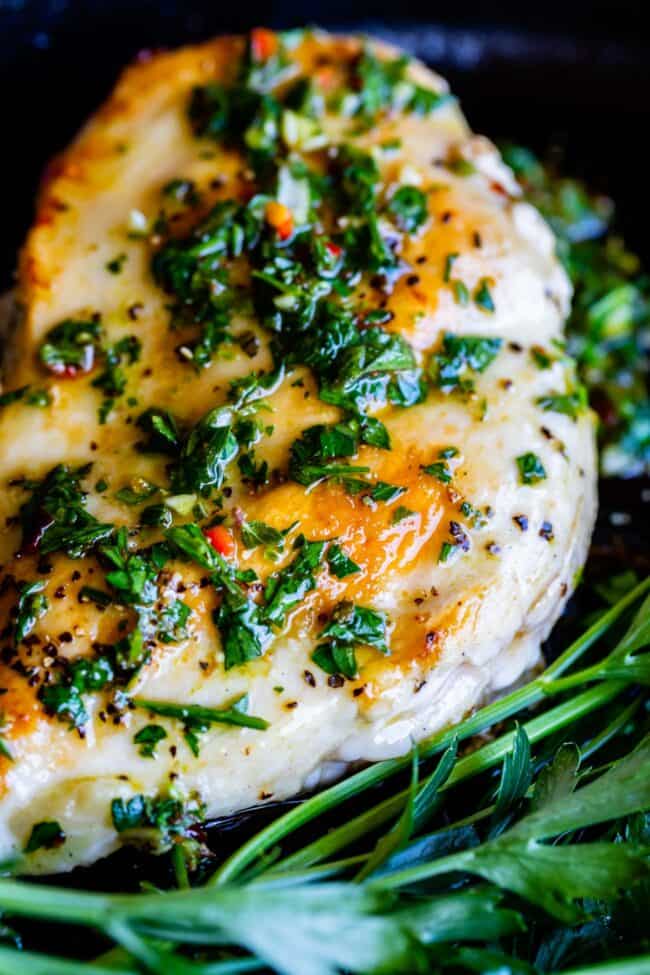 chimichurri sauce on a piece of grilled chicken.