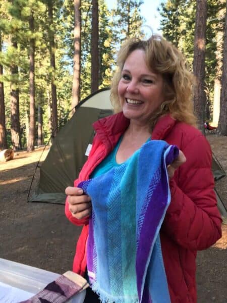 a cute mom holding a blue and purple hand towel.