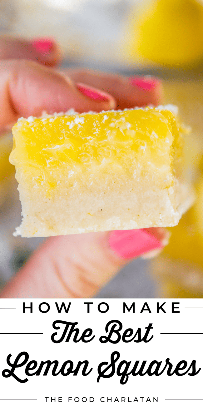 a thick lemon bar being held by a hand.