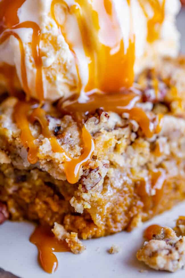 slice of pumpkin pie dump cake drizzled with caramel
