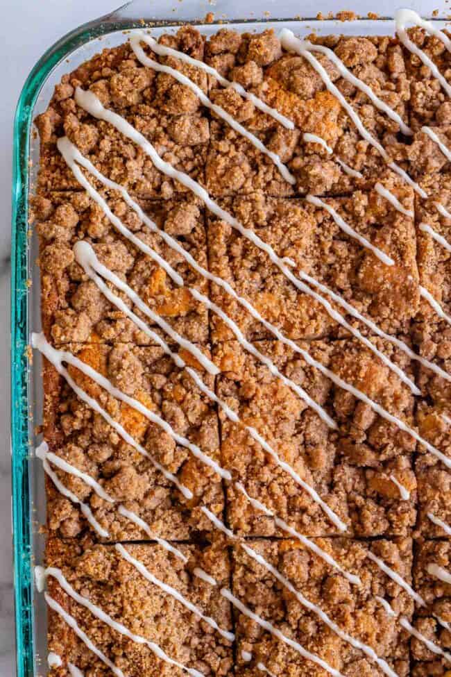 Streusel coffee cake in a 9x13 inch pan with diagonal drizzles of vanilla icing.