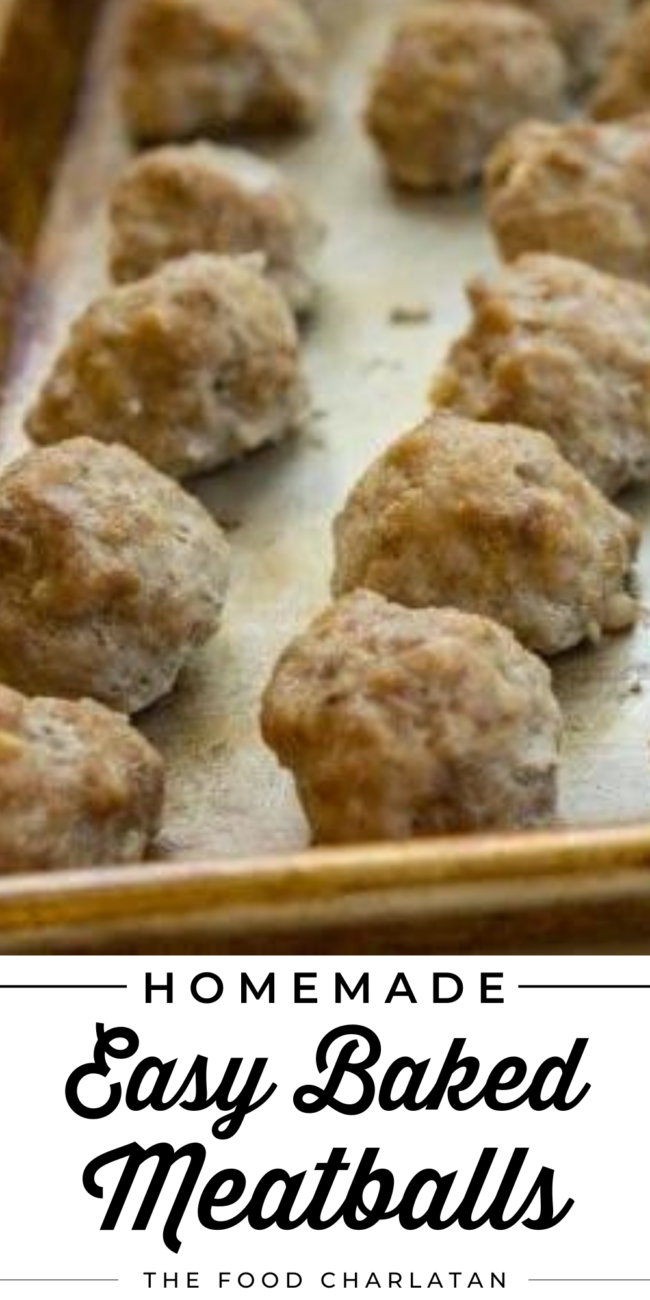baked meatballs lined up on a baking sheet.