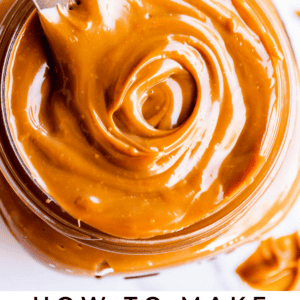 A close-up of a jar filled with creamy, swirled dulce de leche, with a knife resting inside. Text below reads: Dulce de Leche Guide. The Food Charlatan.