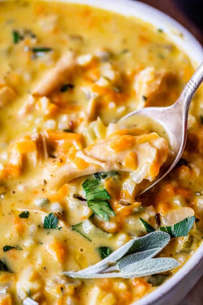 creamy turkey wild rice soup in a white bowl with a spoon