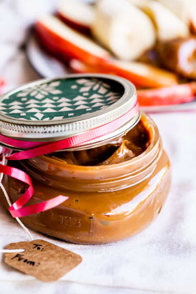 a small mason jar of dulce de leche with a gift tag.
