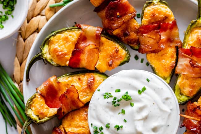 jalapeno poppers around a bowl of ranch. 