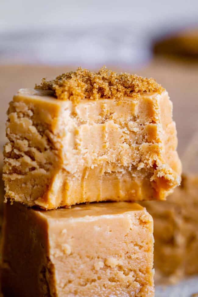 a piece of penuche fudge with a bite taken out topped with brown sugar.