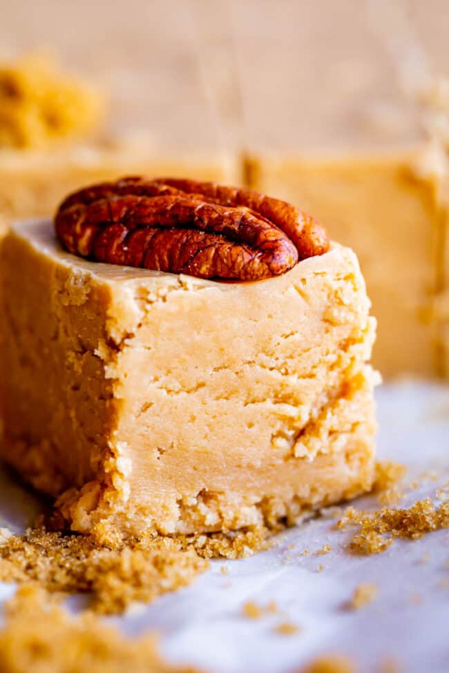 a piece of penuche fudge with a pecan on top.