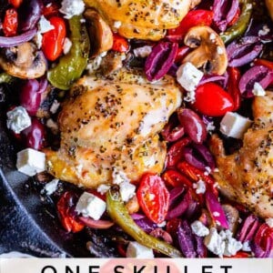 A skillet filled with Greek chicken, sliced olives, cherry tomatoes, mushrooms, peppers, and feta cheese. Text at the bottom reads: One Skillet Greek Chicken with Veggies & Couscous.