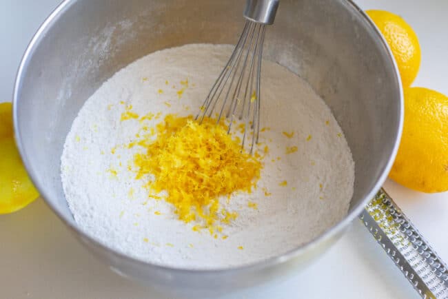 dry ingredients for lemon loaf in a mixing bowl with a whisk. 